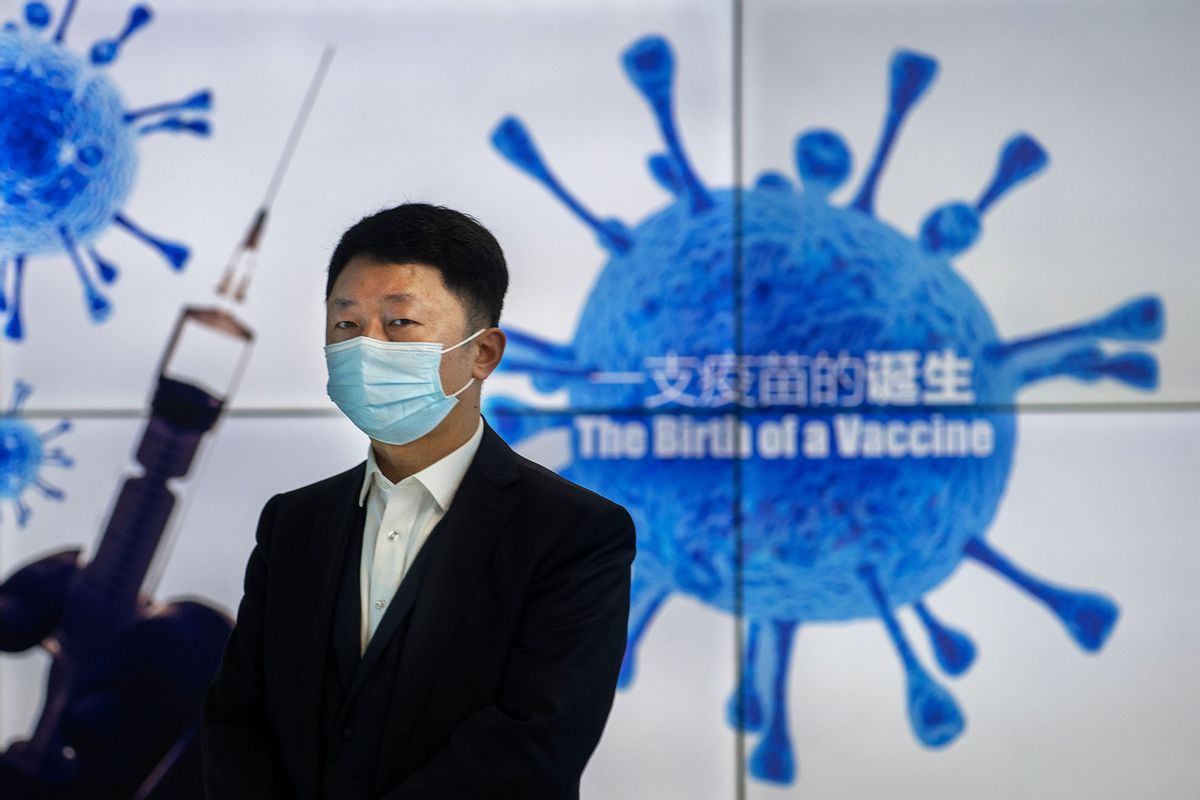 A representative stands in front of a monitor at Sinopharm CNBG's inactivated SARS-Cov-2 vaccine COVID-19 production facility during a media tour organized by the State Council Information Office on February 26, 2021 in Beijing, China. (Kevin Frayer/Getty Images)