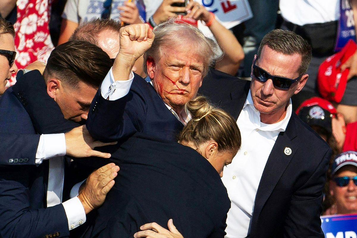 Republican candidate Donald Trump is seen with blood on his face surrounded by secret service agents as he is taken off the stage at a campaign event at Butler Farm Show Inc. in Butler, Pennsylvania, July 13, 2024. (REBECCA DROKE/AFP via Getty Images)