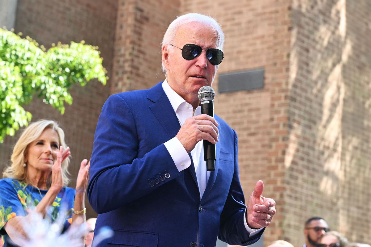 US First Lady Jill Biden (L) looks on as President Joe Biden speaks to supporters and volunteers during a campaign stop at a Biden-Harris campaign office in Harrisburg, Pennsylvania, on July 7, 2024. (SAUL LOEB/AFP via Getty Images)