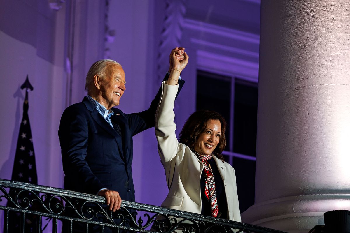 President Joe Biden and Vice President Kamala Harris join hands in the air after watching the fireworks on the National Mall with First Lady Jill Biden and Second Gentleman Doug Emhoff from the White House balcony during a 4th of July event on the South Lawn of the White House on July 4, 2024 in Washington, DC. (Samuel Corum/Getty Images)