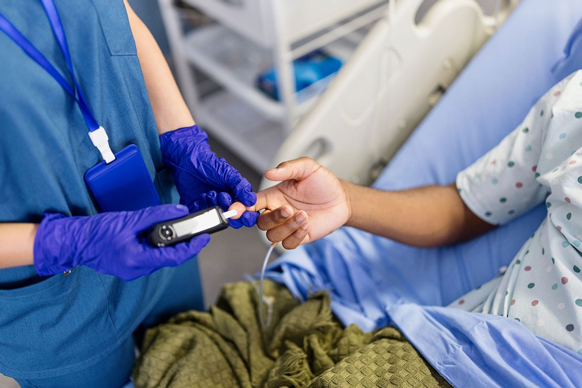 Nurse taking blood to check sugar levels of a patient (Getty Images/Anchiy)