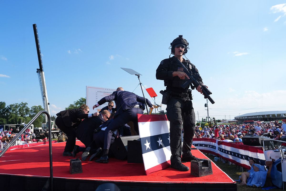 Secret service agents cover former president Donald Trump during a campaign rally for former President Donald Trump at Butler Farm Show Inc. on Saturday, July 13, 2024 in Butler, Pa. (Jabin Botsford/The Washington Post via Getty Images)