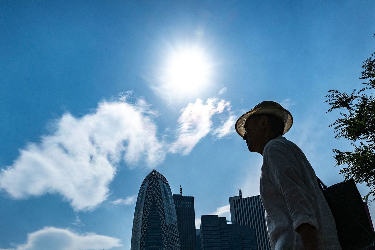 A man walks in the Shinjuku district of Tokyo where temperatures have topped 35 degrees Celsius on July 8, 2024. (PHILIP FONG/AFP via Getty Images)