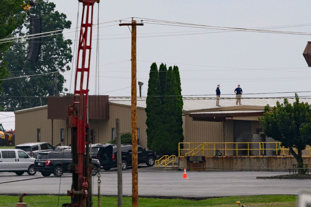 Two FBI investigators scan the roof of AGR International Inc, the building adjacent to the Butler Fairgrounds, from which alleged shooter Matthew Thomas Crooks fired at former President Donald J. Trump, in the aftermath of the attempted assassination at a campaign rally on July 14, 2024, in Butler, Pennsylvania. (Jeff Swensen/Getty Images)