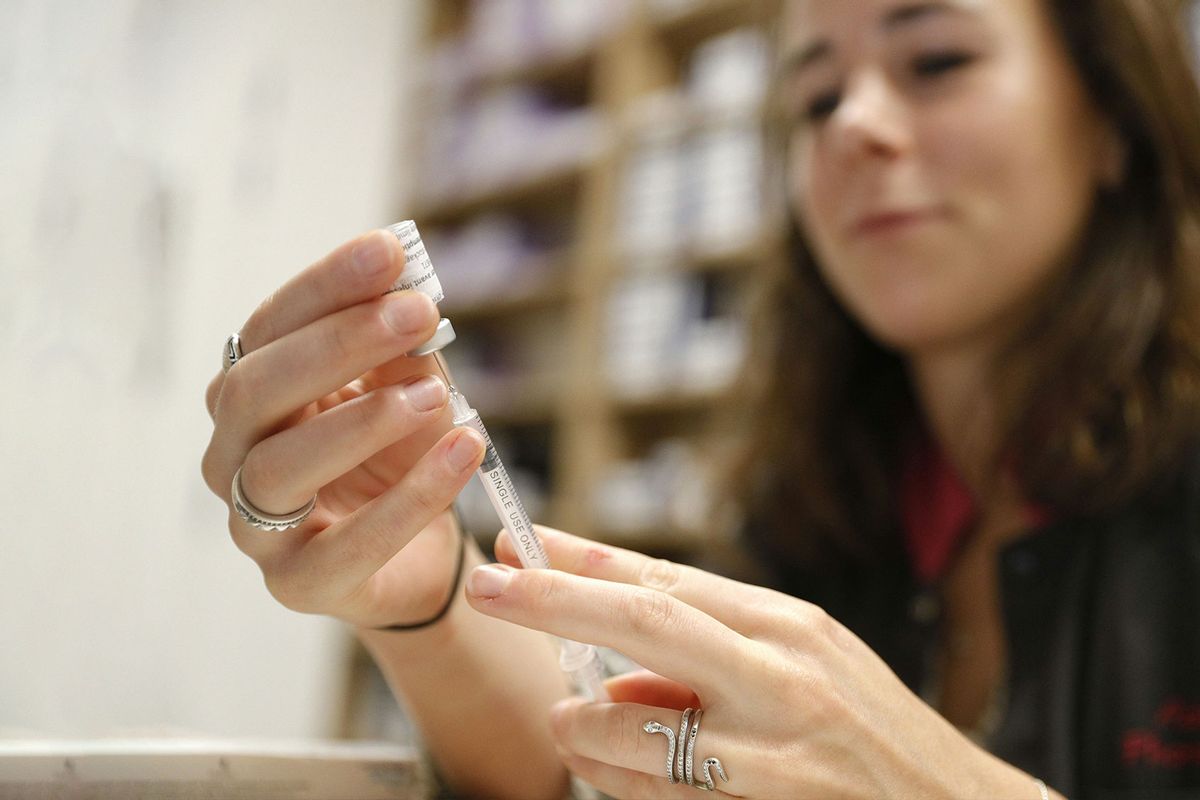 An employee prepares a dose of Comirnaty Omicron XBB 1.5 Pfizer vaccine for COVID-19 at a pharmacy in Ajaccio, on October 5, 2023, during a new COVID-19 vaccination campagin on the French Mediterranean island of Corsica. (PASCAL POCHARD-CASABIANCA/AFP via Getty Images)