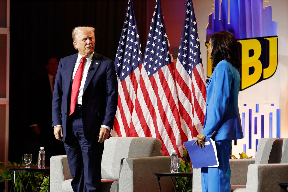 Former US President and 2024 Republican presidential nominee Donald Trump stands up to depart after answering questions as moderator and journalist Rachel Scott (R) looks on during the National Association of Black Journalists annual convention in Chicago, Illinois, on July 31, 2024. (KAMIL KRZACZYNSKI/AFP via Getty Images)