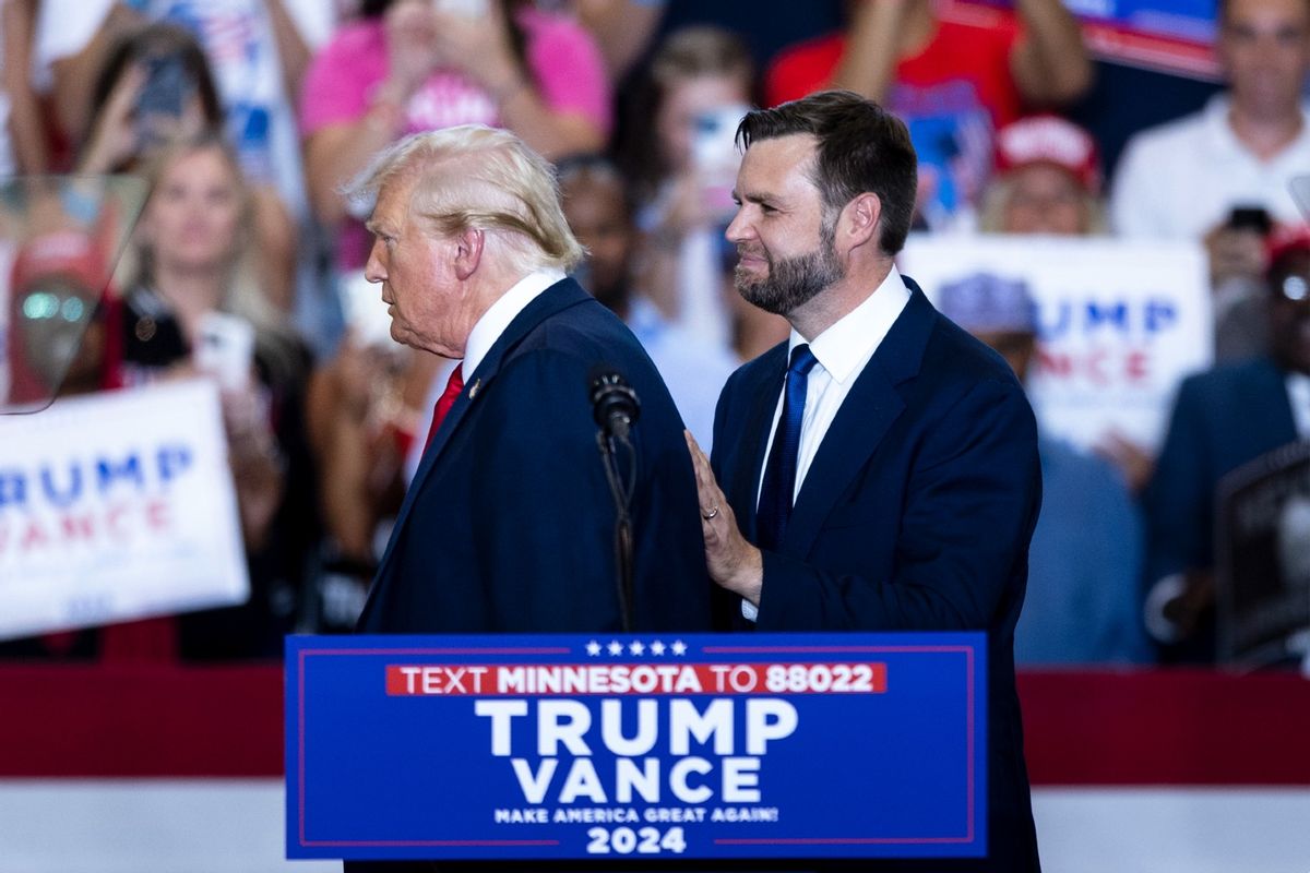 Republican presidential nominee Donald Trump is greeted by running mate Senator J.D. Vance on stage during a campaign rally inside the Herb Brooks National Hockey Center at St. Cloud State University in St. Cloud, Minnesota, on July 27, 2024.  (Tom Brenner for The Washington Post via Getty Images)