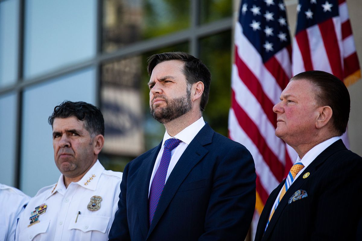 Republican vice presidential candidate, U.S. Sen J.D. Vance (R-OH) (C) listens as members of the police department speak during a press conference at the Shelby Township Police Department on August 7, 2024 in Shelby Township, Michigan. (Emily Elconin/Getty Images)