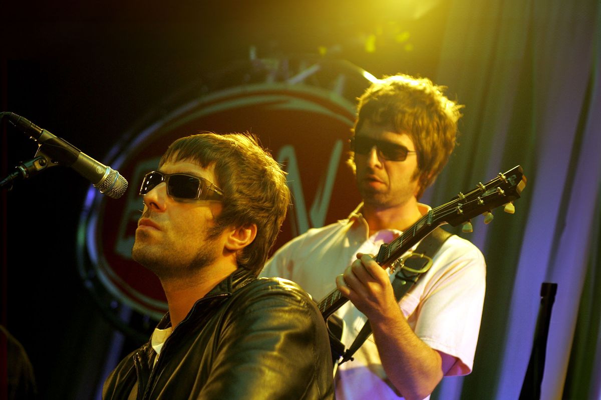 Liam Gallagher & Noel Gallagher performing live onstage. (Paul Bergen/Redferns/GEtty Images)