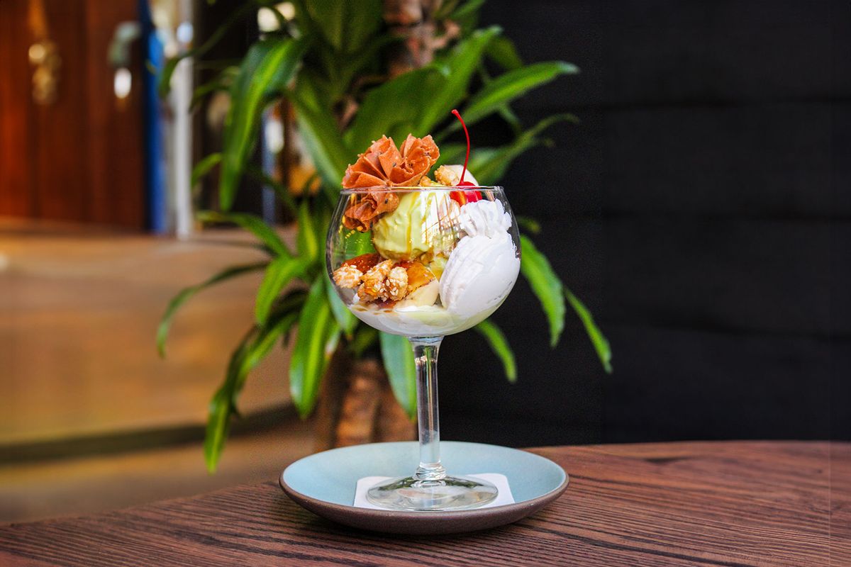 Green Curry Ice Cream Sunday with Candied Peanuts, Bruleed Banana, Whipped Coconut Cream and Fish Sauce Caramel (Photo courtesy of Proxi and Kinship Company)