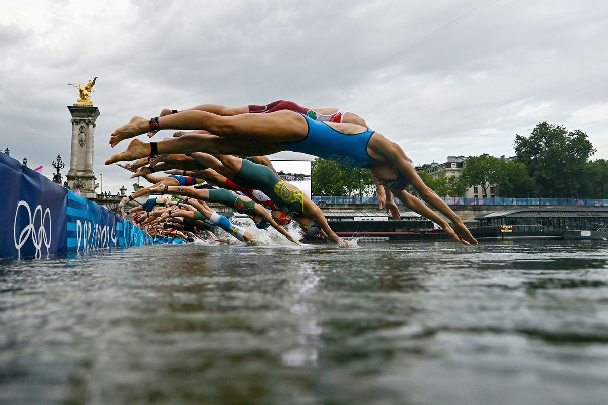 Athletes compete in the swimming race in the Seine during the women's individual triathlon at the Paris 2024 Olympic Games at Pont Alexandre III on July 31, 2024 in Paris, France. (Martin Bureau - Pool/Getty Images)