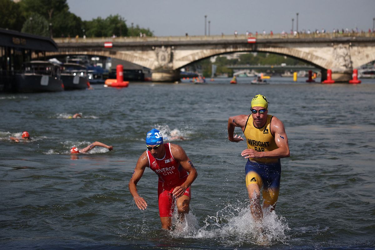 Chile's Gaspar Riveros (L) and Barbados' Matthew Wright compete in the swimming stage in the Seine during the men's individual triathlon at the Paris 2024 Olympic Games in central Paris on July 31, 2024. (ANNE-CHRISTINE POUJOULAT/AFP via Getty Images)