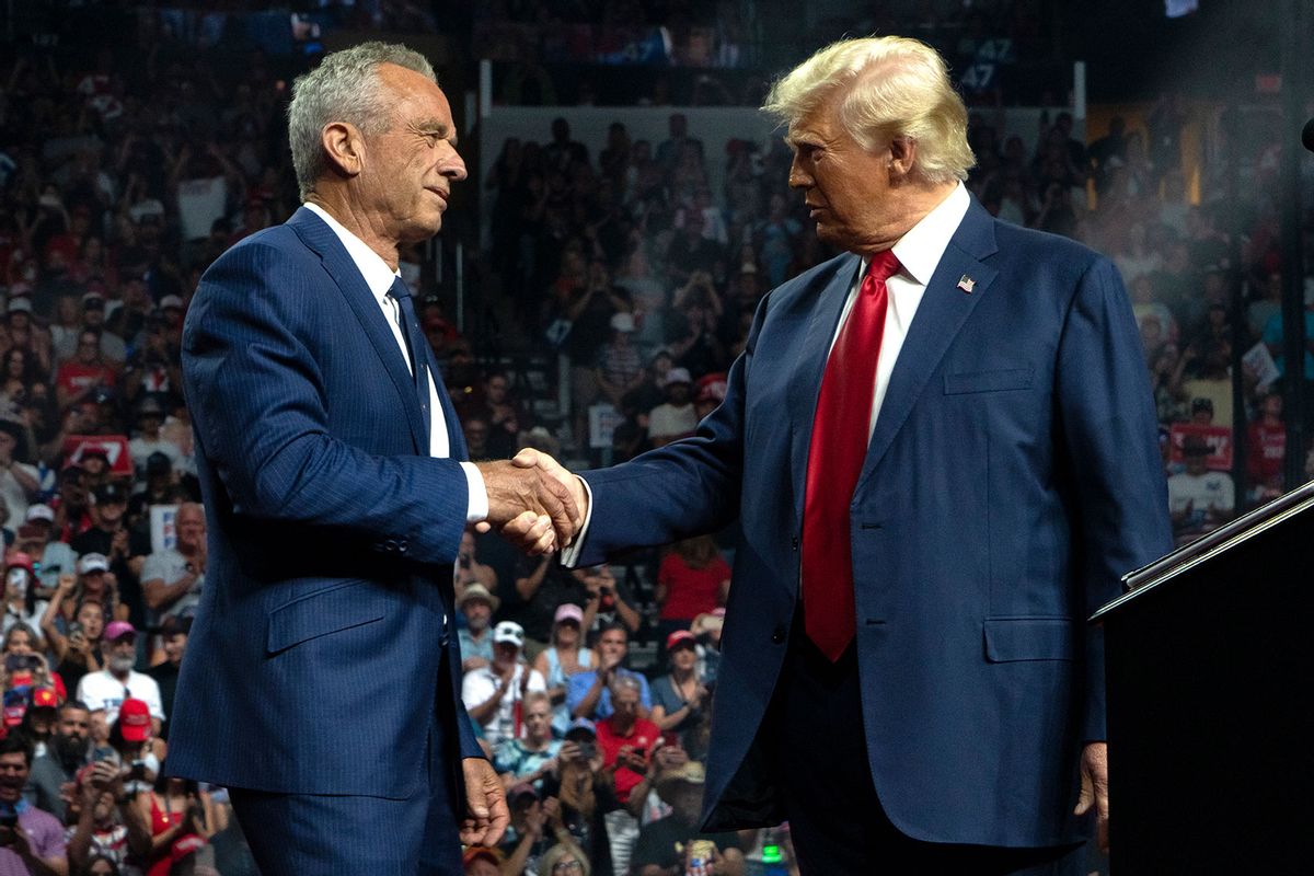 Former Republican presidential candidate Robert F. Kennedy Jr. and Republican presidential nominee, former U.S. President Donald Trump shake hands during a campaign rally at Desert Diamond Arena on August 23, 2024 in Glendale, Arizona. (Rebecca Noble/Getty Images)