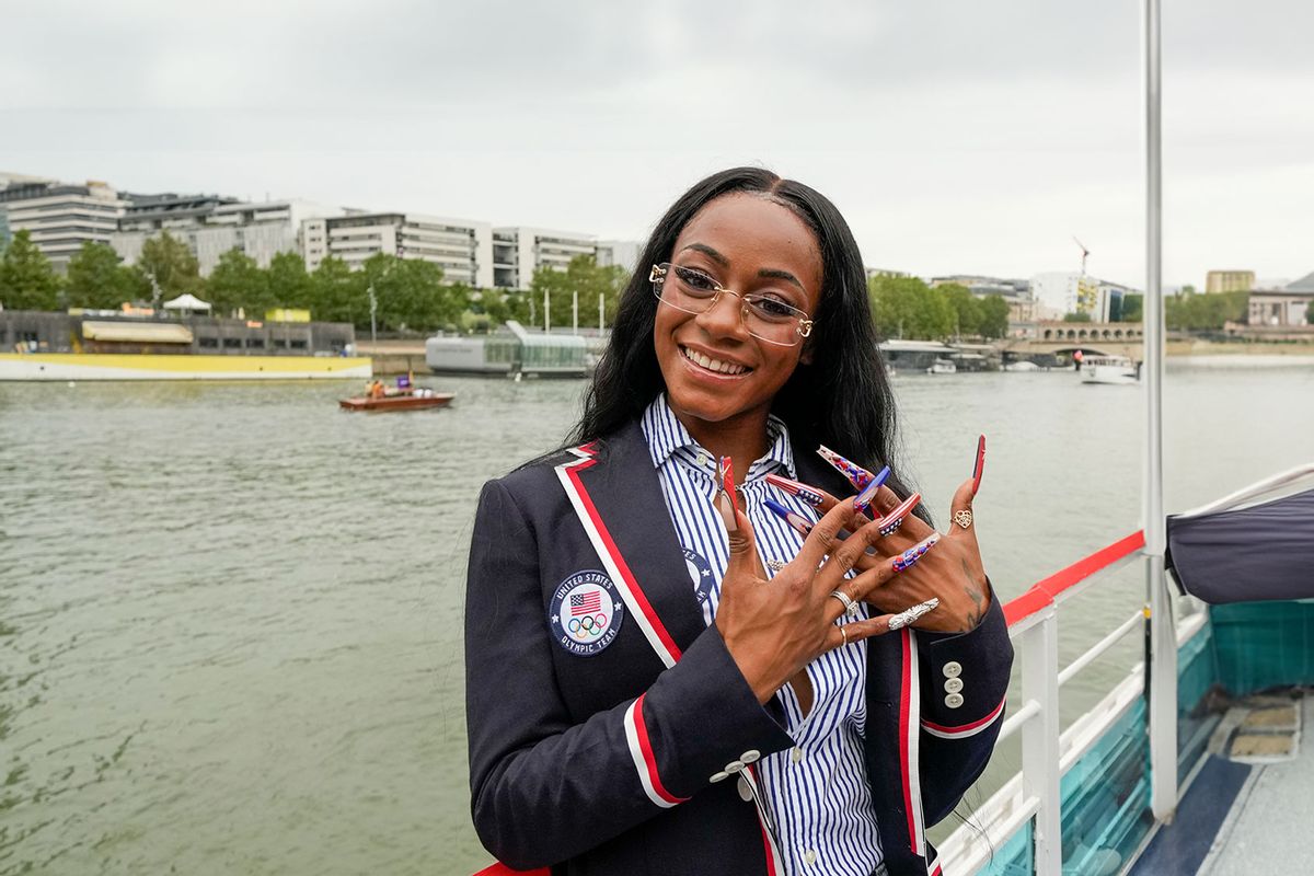 Sha'Carri Richardson poses for a photo while riding with teammates on a boat with teammates along the Seine River during the Opening Ceremony of the Olympic Games Paris 2024 on July 26, 2024 in Paris, France. (Ashley Landis - Pool/Getty Images)