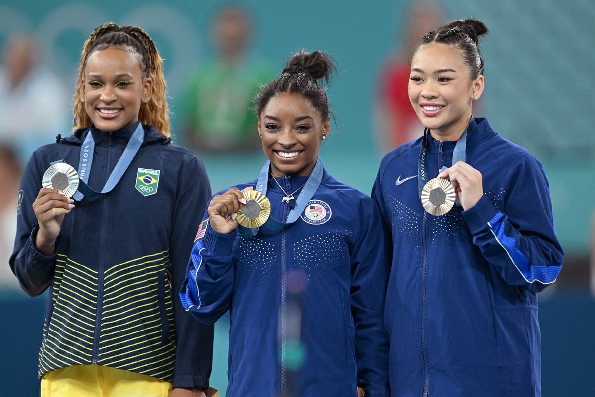 Bronze medal, US' Sunisa Lee, winner gold medal US' Simone Biles and Brazilian Rebeca Andrade celebrate on the podium after the women's all-around final of gymnastics competition at the Paris 2024 Olympic Games, on Thursday 01 August 2024 in Paris, France.  ( ANTHONY BEHAR/BELGA MAG/AFP via Getty Images)