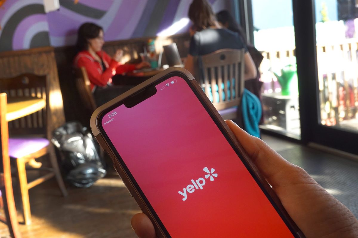 A Yelp splash page is displayed on a cell phone on November 14, 2023 in Chicago, Illinois.  (Photo Illustration by Scott Olson/Getty Images)