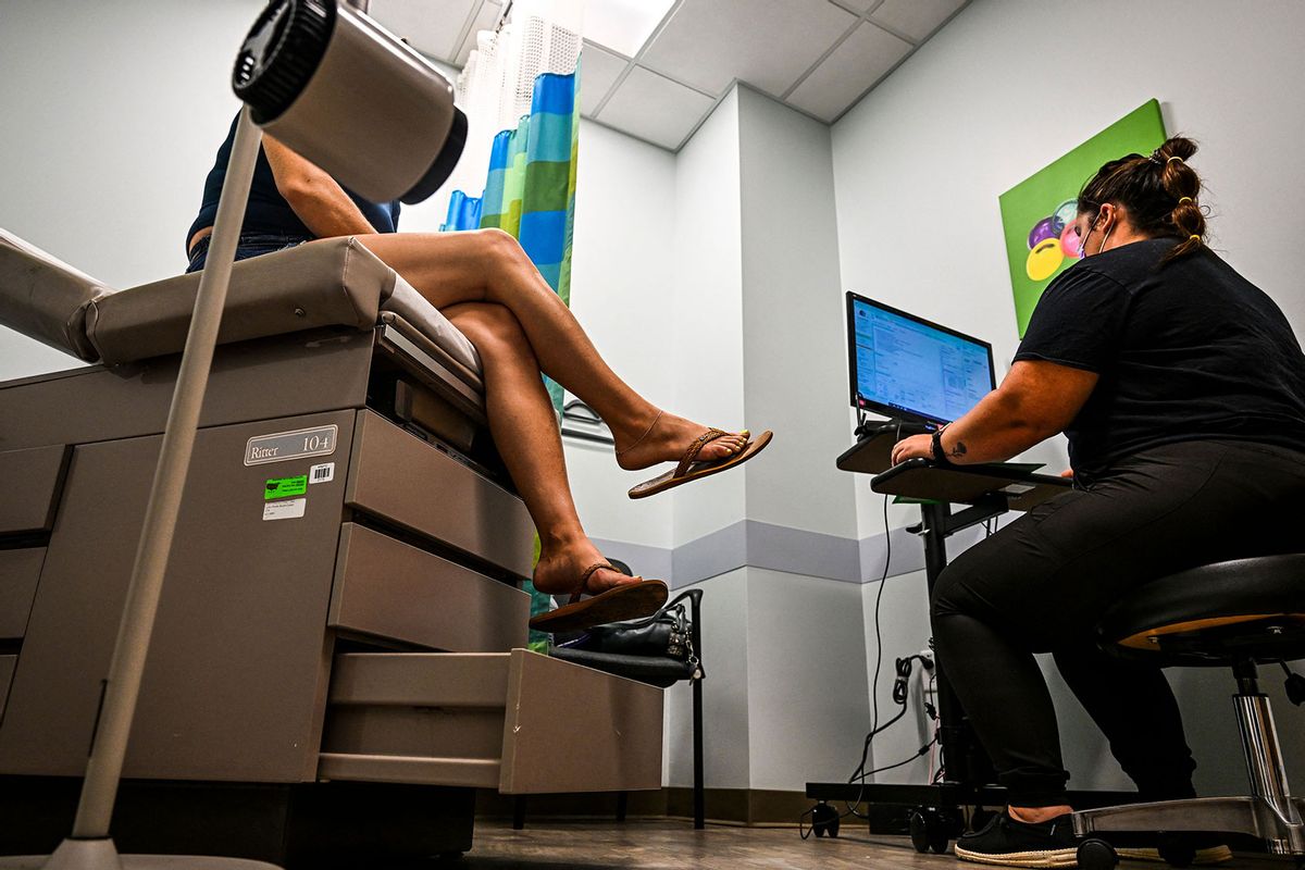 A woman, who chose to remain anonymous, talks to Doctor Audrey (R) before recieving an abortion at a Planned Parenthood Abortion Clinic in West Palm Beach, Florida, on July 14, 2022. (CHANDAN KHANNA/AFP via Getty Images)