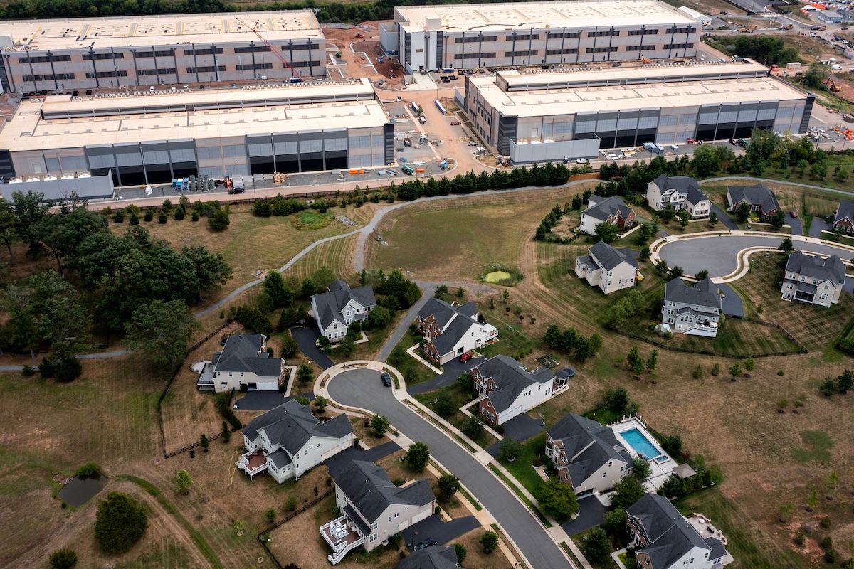 STONE RIDGE, VIRGINIA - JULY 17: In an aerial view, an Amazon Web Services data center is shown situated near single-family homes on July 17, 2024 in Stone Ridge, Virginia. Northern Virginia is the largest data center market in the world, according to a report this year cited in published accounts, but is facing headwinds from availability of land and electric power.  ((Photo by Nathan Howard/Getty Images))