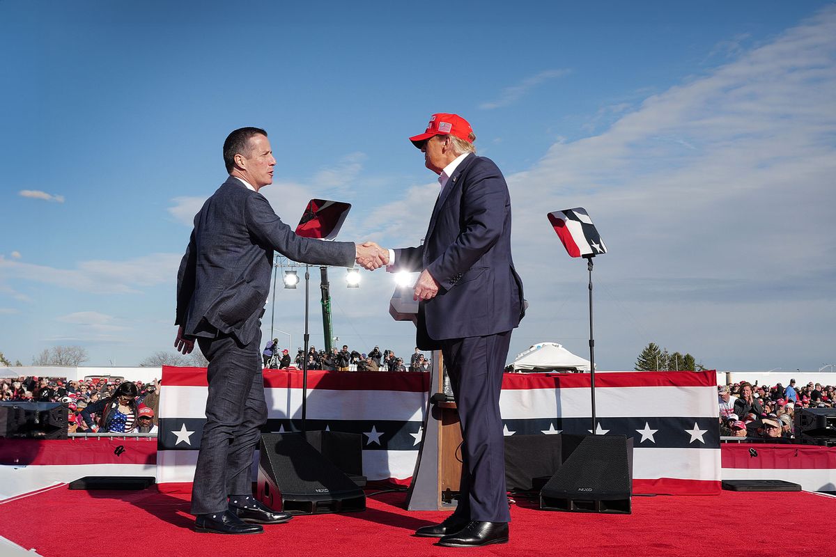 Republican presidential candidate former President Donald Trump greets Ohio Republican candidate for US Senate Bernie Moreno during a rally at the Dayton International Airport on March 16, 2024 in Vandalia, Ohio. (Scott Olson/Getty Images)