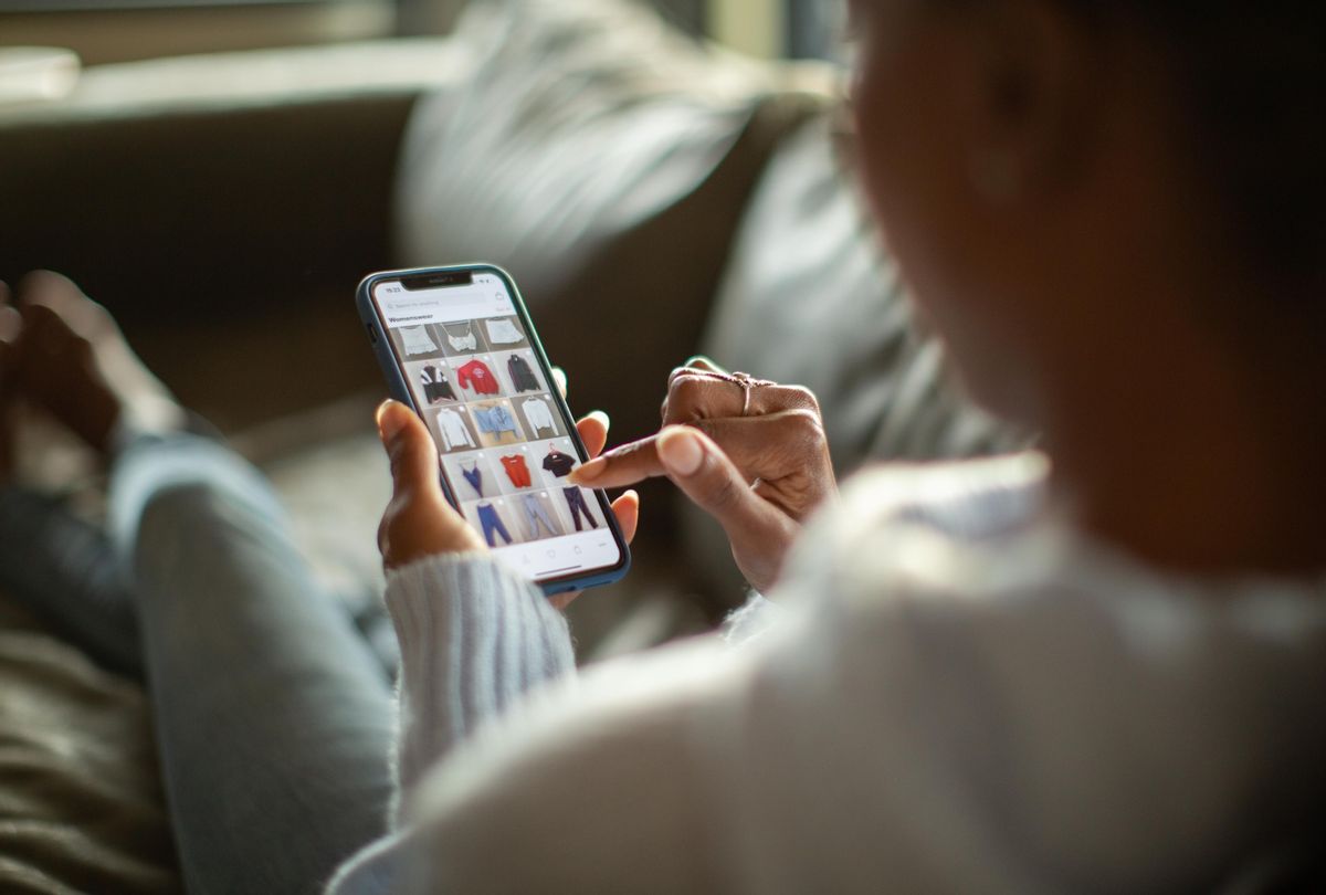 Woman purchasing clothes on a mobile app. (Getty Images/Alistair Berg)