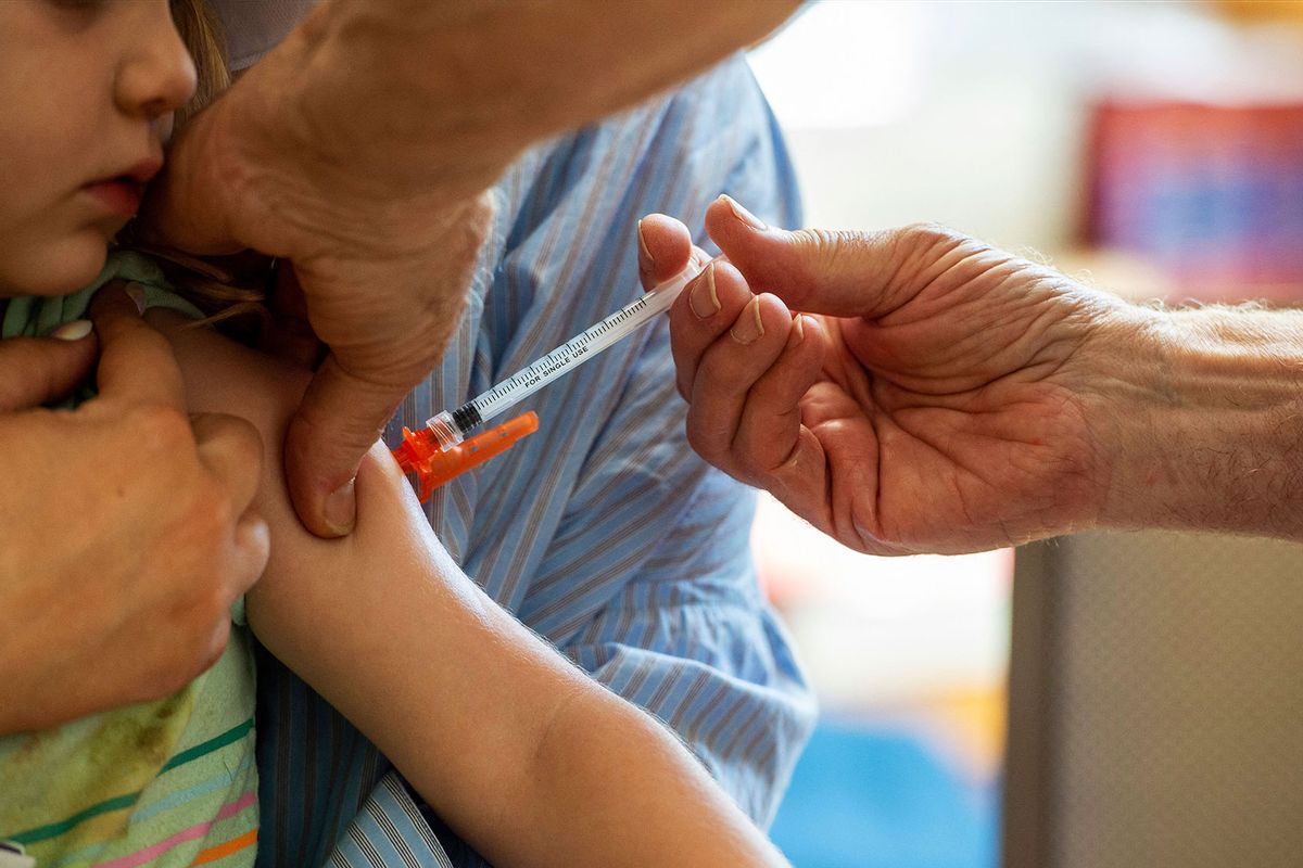 A young child receives a Moderna Covid-19 6 months to 5 years vaccination at Temple Beth Shalom in Needham, Massachusetts on June 21, 2022. (JOSEPH PREZIOSO/AFP via Getty Images)