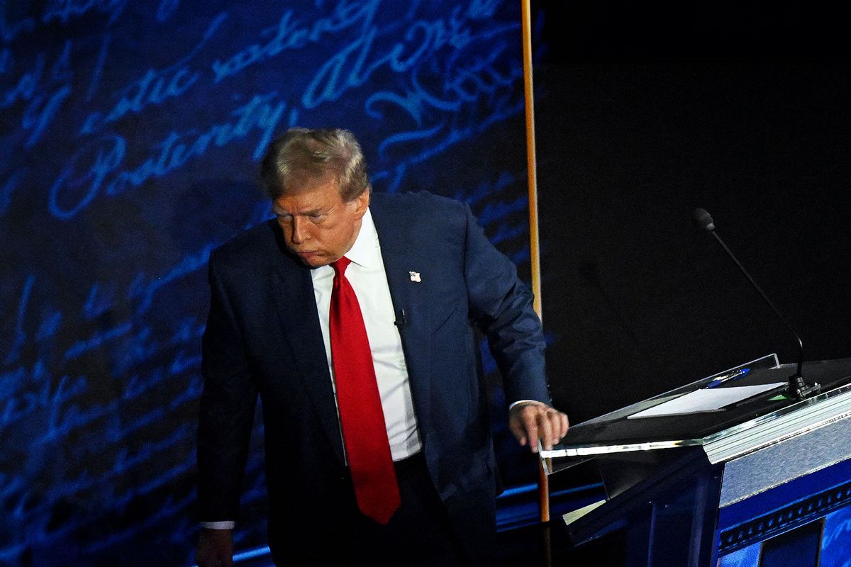 Donald Trump walks away during a commercial break as Vice President Kamala Harris take notes during the presidential debate at the National Constitution Center in Philadelphia, Sept. 10, 2024. (SAUL LOEB/AFP via Getty Images)