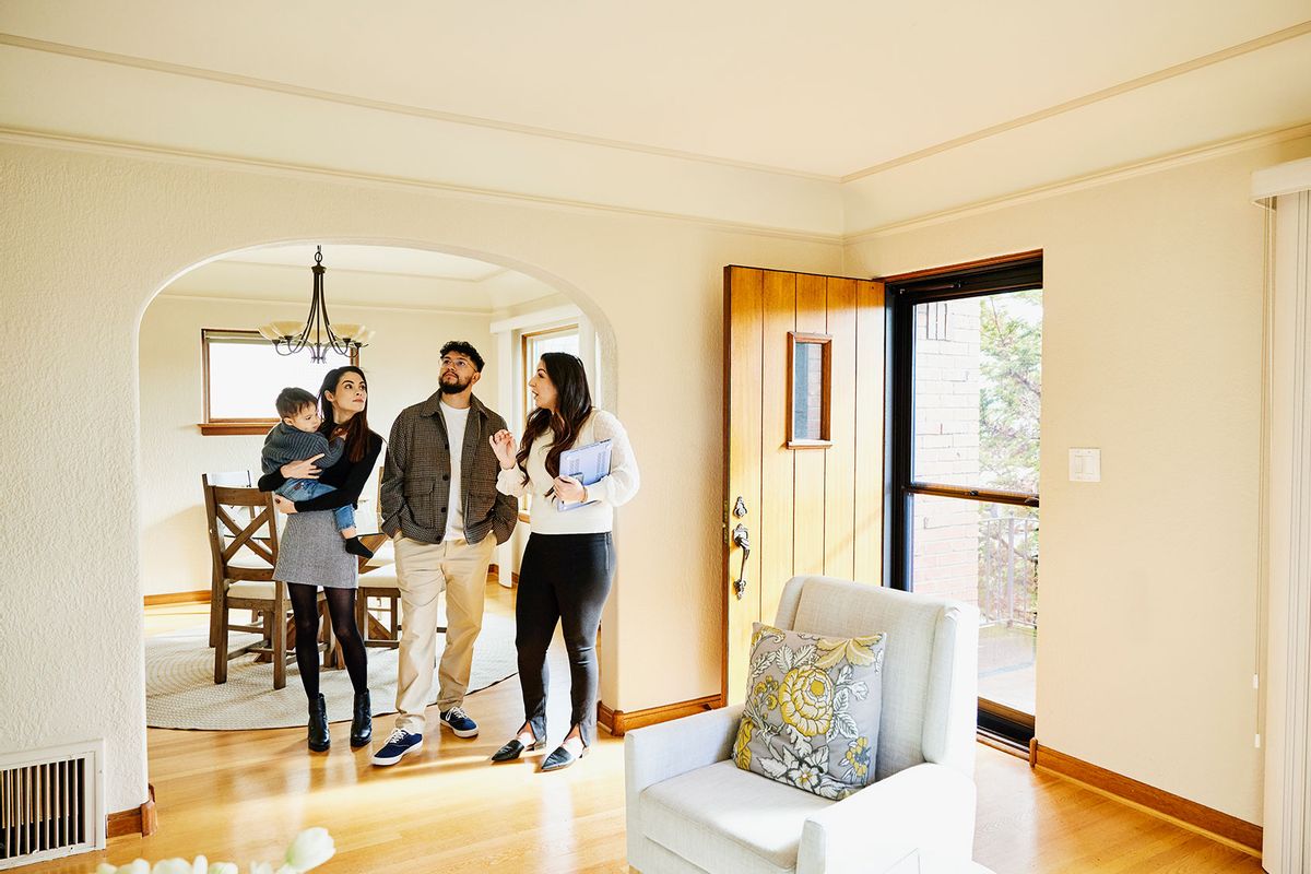 Family looking at a home for sale with a real estate agent (Getty Images/Thomas Barwick)