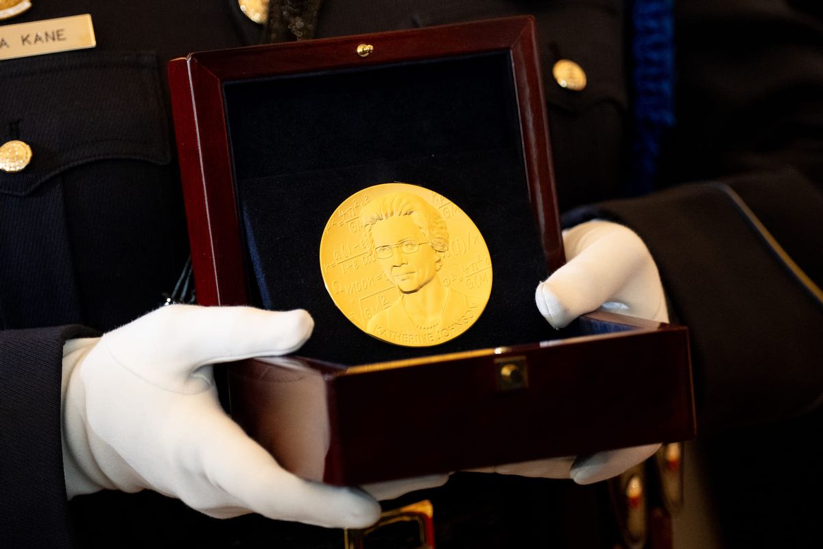 A member of the U.S. Capitol Police carries a Congressional Gold Medal for Katherine Johnson during a ceremony on Capitol Hill on September 18, 2024 in Washington, DC. The Congressional Gold Medal was presented to family members of Katherine Johnson, Dorothy Vaughan, Mary Jackson, and Christine Darden, as well as a medal to all the "women mathematicians, engineers, and 'human computers' in the U.S space program from the 1930s to the 1970s," often referred to as the "hidden figures" of the space race. (Photo by Andrew Harnik/Getty Images)