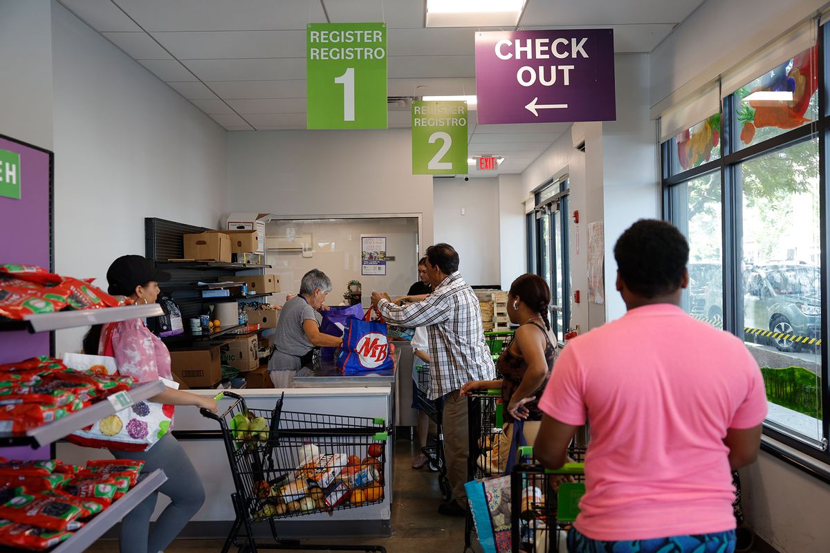 Guests wait to check out at the Salem Pantry. (Danielle Parhizkaran/The Boston Globe via Getty Images)