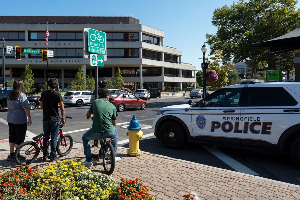 People watch as Springfield Police Department officers investigate the Springfield City Hall after bomb threats were made against buildings earlier in the day in Springfield, Ohio on September 12, 2024. (ROBERTO SCHMIDT/AFP via Getty Images)