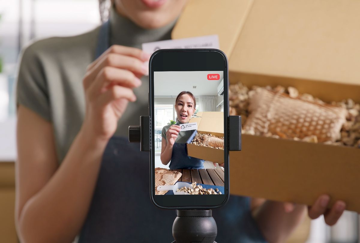 Young woman records video. (Getty Images/ChayTee)