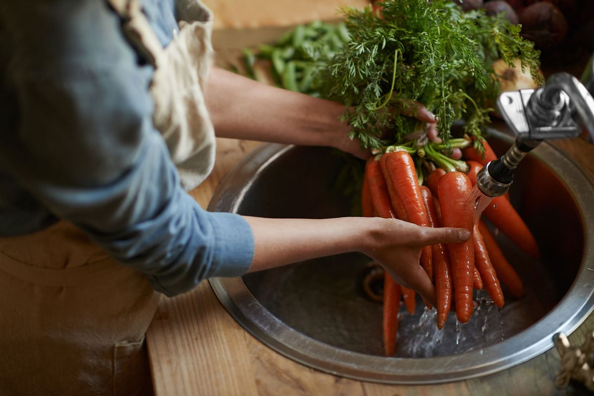 Washing carrots in the sink (Getty Images/PeopleImages)