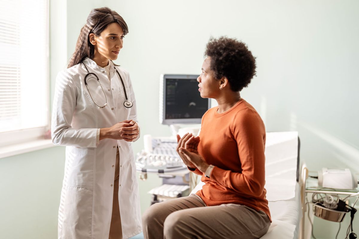 A doctor talks with her patient about her concerns. (Getty Images/ljubaphoto)