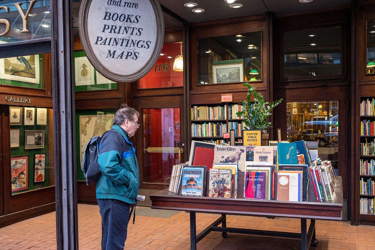 A pedestrian stops at an outdoor table of books November 9, 2022 at the Argosy Book Store in New York City. (Robert Nickelsberg/Getty Images)