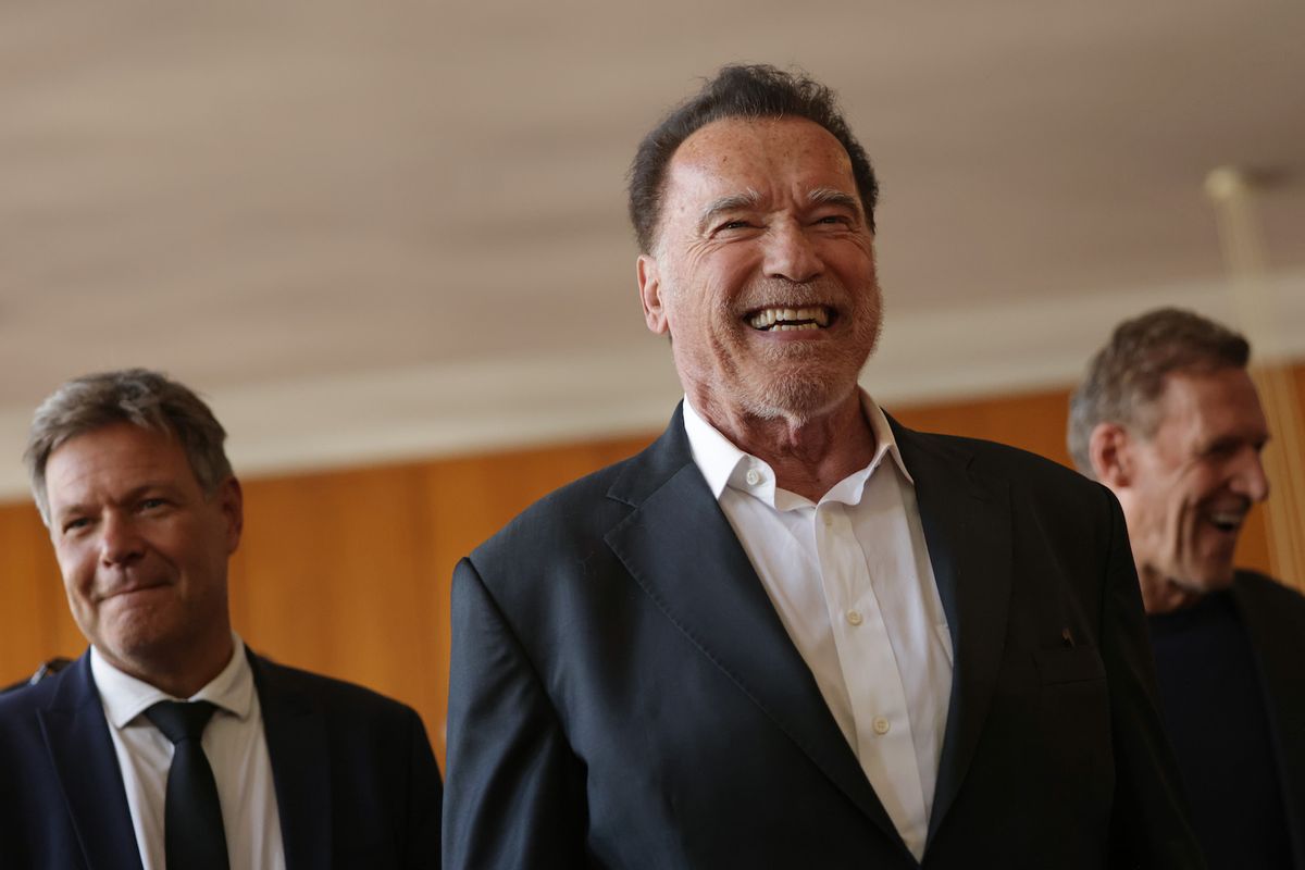 Former California Governor Arnold Schwarzenegger (C) arrives with German Economy and Climate Action Minister Robert Habeck at an event in which Schwarzenegger received an honorary degree from the Hertie School on September 17, 2024 in Berlin, Germany. The award is in honour of Schwarzenegger's commitment to climate protection and civil society. (Photo by Sean Gallup/Getty Images)