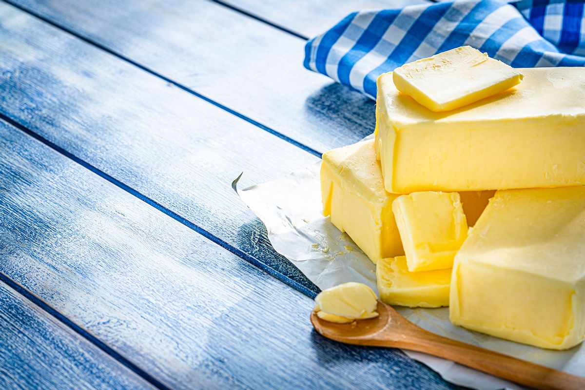 Butter blocks and pieces on blue table (Getty Images/fcafotodigital)