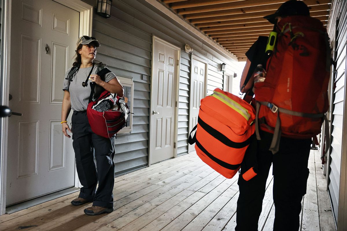 Dr. Khristina Meissner (R) and nurse practitioner Jen Felter, both volunteers, check on residents in an apartment complex in the aftermath of Hurricane Helene flooding on October 7, 2024 in Swannanoa, North Carolina. (Mario Tama/Getty Images)