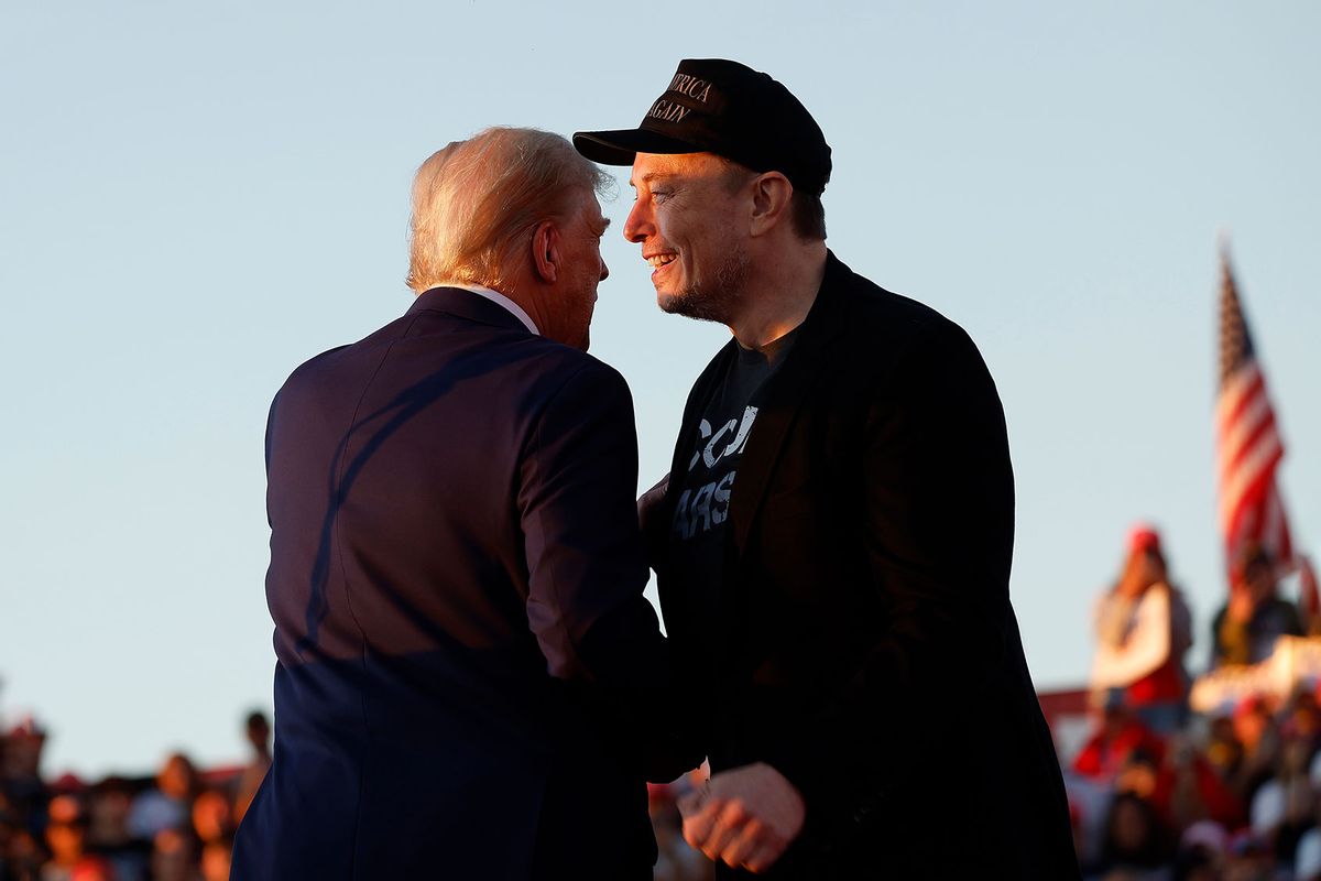 Elon Musk embraces Republican presidential nominee, former President Donald Trump during a campaign rally at the Butler Farm Show fairgrounds on October 05, 2024 in Butler, Pennsylvania. (Anna Moneymaker/Getty Images)