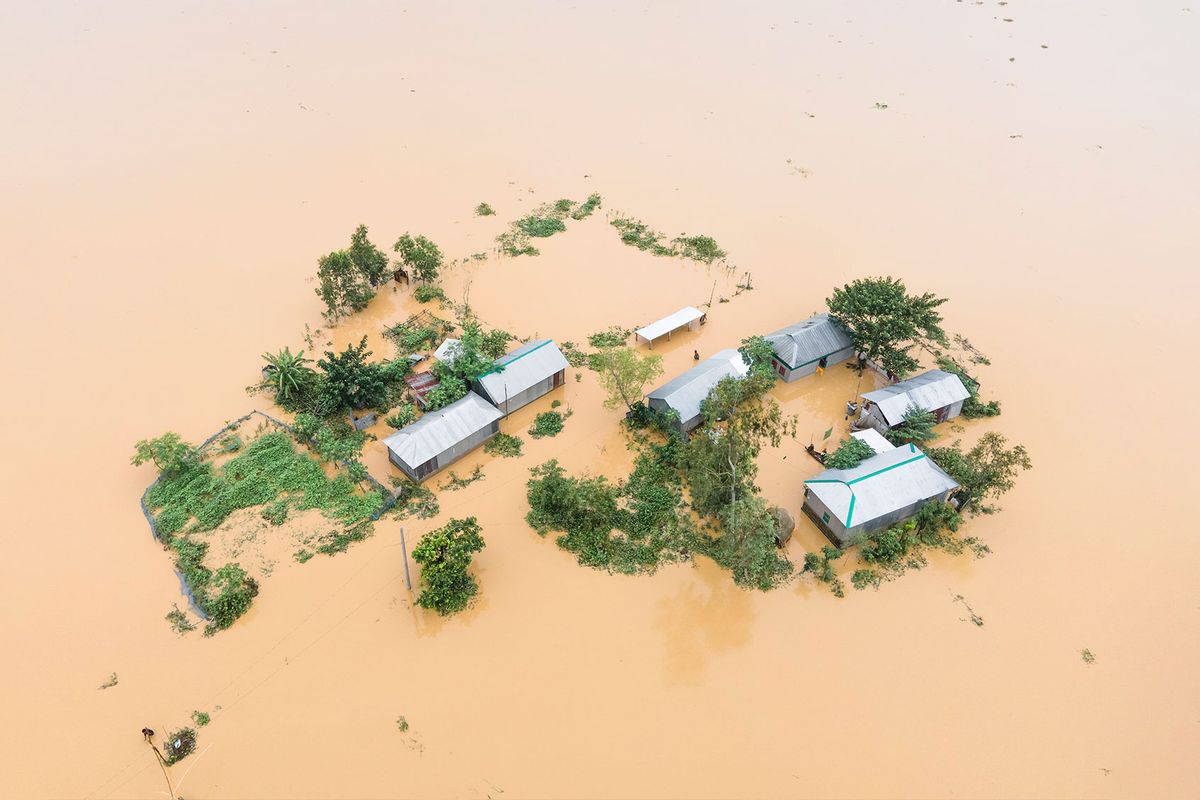 Heavy rains and water from upstream India submerge homes in a village in Jhenaigati upazila of Sherpur district, Bangladesh, on October 5, 2024. (Muhammad Amdad Hossain/NurPhoto via Getty Images)