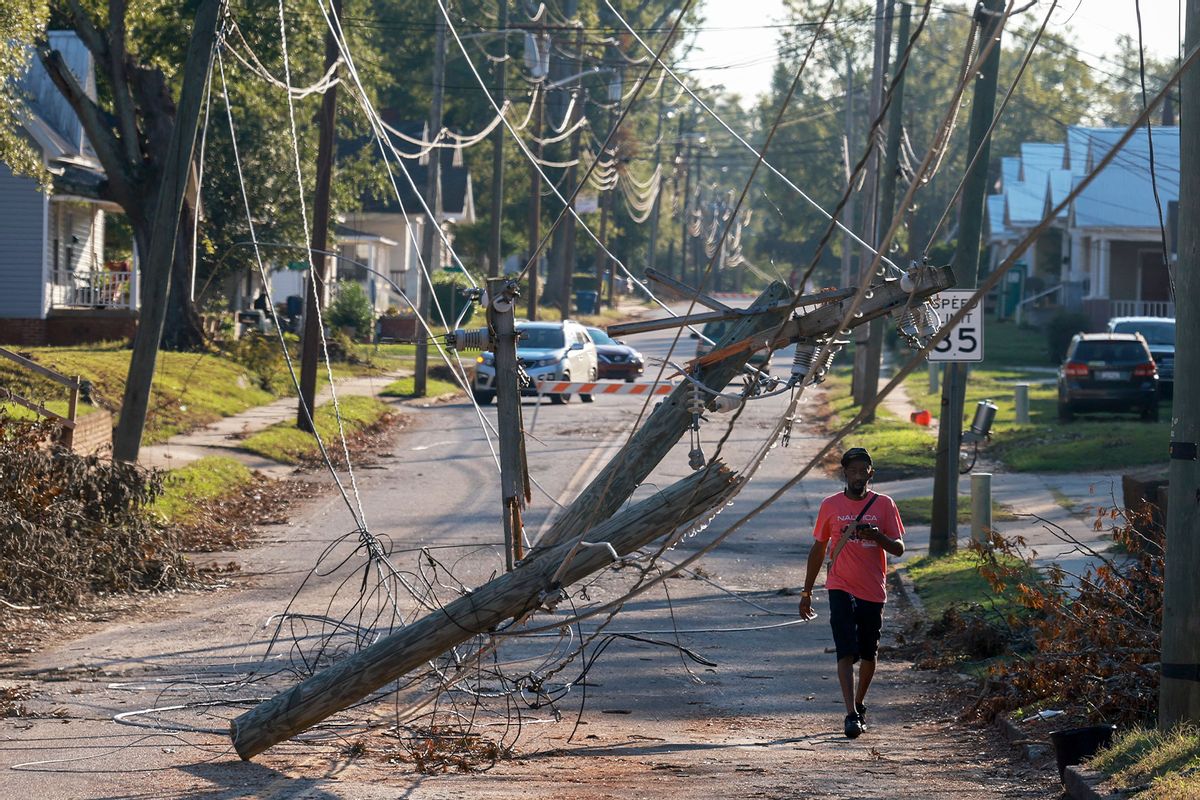 A person walks past downed power lines as people deal with the aftermath of Hurricane Helene on October 05, 2024 in Greenwood, South Carolina. (Joe Raedle/Getty Images)