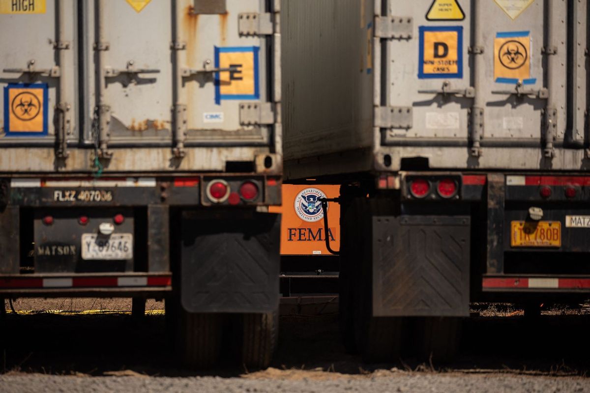 A FEMA logo is pictured behind a refrigerated storage container adjacent to the Maui Police Forensic Facility where human remains are stored in the aftermath of the Maui wildfires in Wailuku, Hawaii on August 17, 2023. (Photo by YUKI IWAMURA/AFP via Getty Images)
