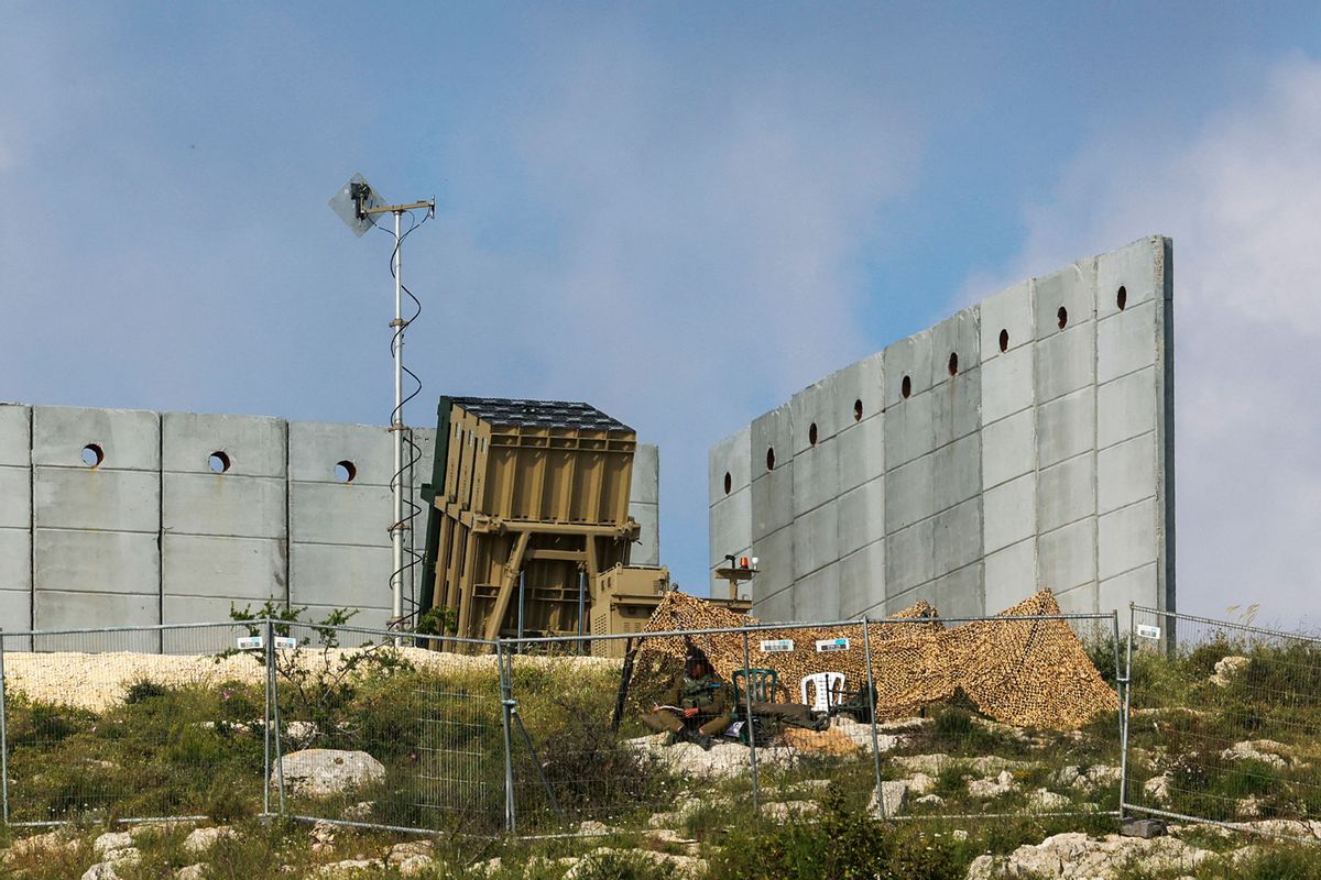 An Israeli soldier takes up a position in front of a battery of an Iron Dome air defence system near Jerusalem on April 15, 2024, amid the ongoing conflict. (MENAHEM KAHANA/AFP via Getty Images)