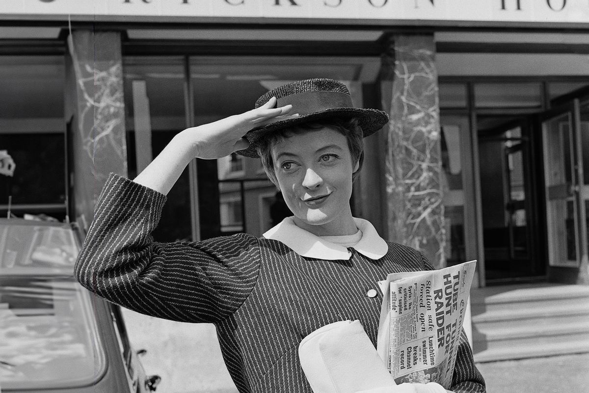 English actress Maggie Smith holding a copy of the Evening Standard newspaper outside Mcann-Erickson House in Fetter Lane, London, 22nd August 1957. (Evening Standard/Hulton Archive/Getty Images)