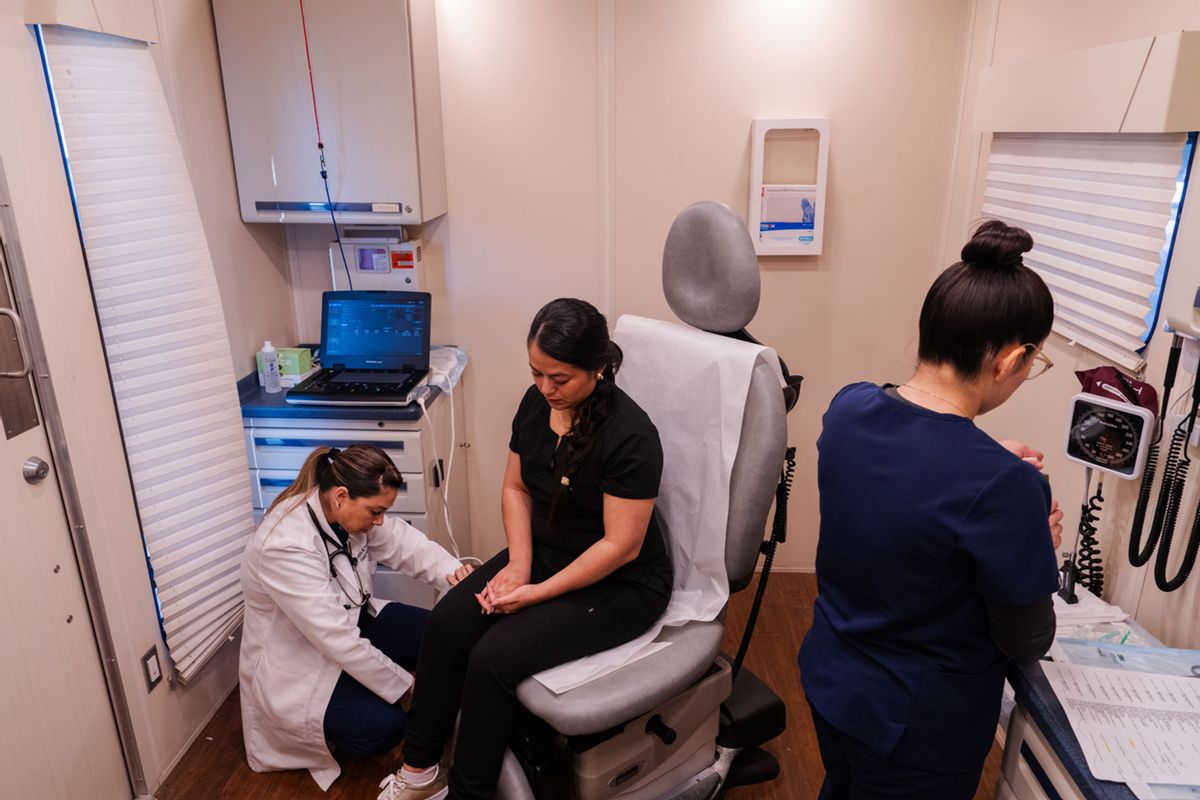 Nurse practitioner Angela Tanguma (left) and medical assistant Adriana Rojas (right) treat Ana Osario in the UniMóvil, a mobile clinic that serves Texas' rural Rio Grande Valley. (Carlos Cuadros / University of Texas Rio Grande Valley School of Medicine)