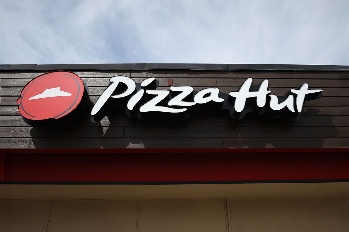 A sign is posted on the exterior of a Pizza Hut restaurant on March 25, 2024 in San Pablo, California. (Justin Sullivan/Getty Images)