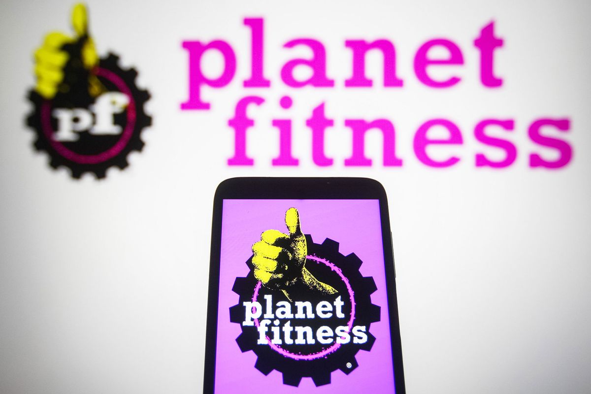 Planet Fitness (PFIP LLC) logo is seen displayed on a smartphone and a pc screen. (Pavlo Gonchar/SOPA Images/LightRocket via Getty Images)