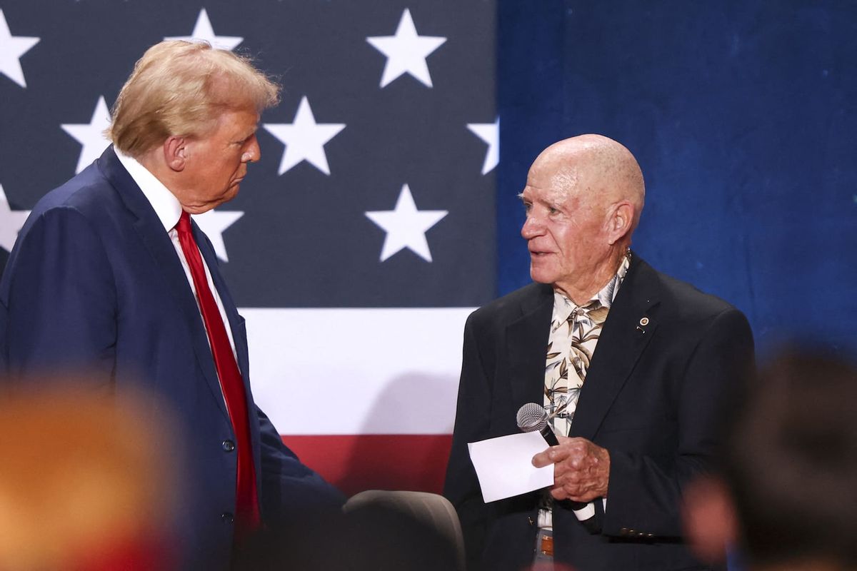 Former US President and Republican presidential candidate Donald Trump receives a Purple Heart medal from a Vietnam veteran (R) during a town hall event at the Crown Complex in Fayetteville, North Carolina, on October 4, 2024. (Photo by Logan Cyrus / AFP)