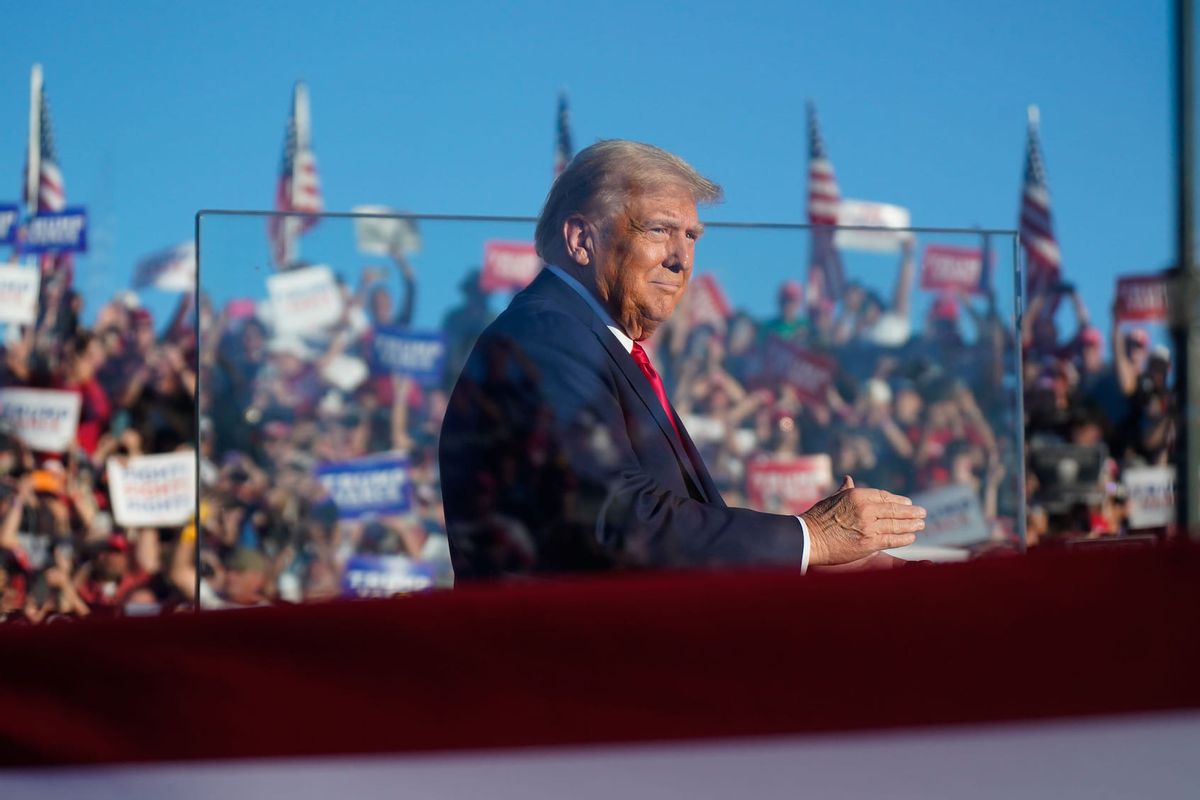 Republican presidential nominee former president Donald Trump stands behind bullet resistant glass as he arrives to speak at a campaign event at the Butler Farm Show, Saturday, Oct. 5, 2024, in Butler, Pa. This is the first time former president Donald Trump has returned to Butler since he was injured during an attempted assassination on July 13. (Photo by Jabin Botsford/The Washington Post via Getty Images)