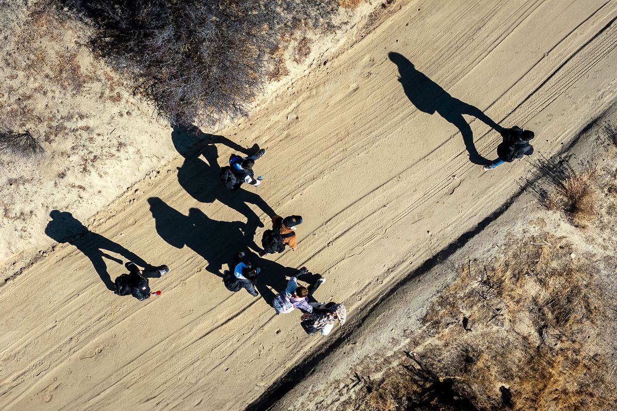 From an aerial view Colombian asylum seekers walk along a desert road after crossing the U.S.-Mexico on September 22, 2024 near Jacumba Hot Springs, California. (John Moore/Getty Images)