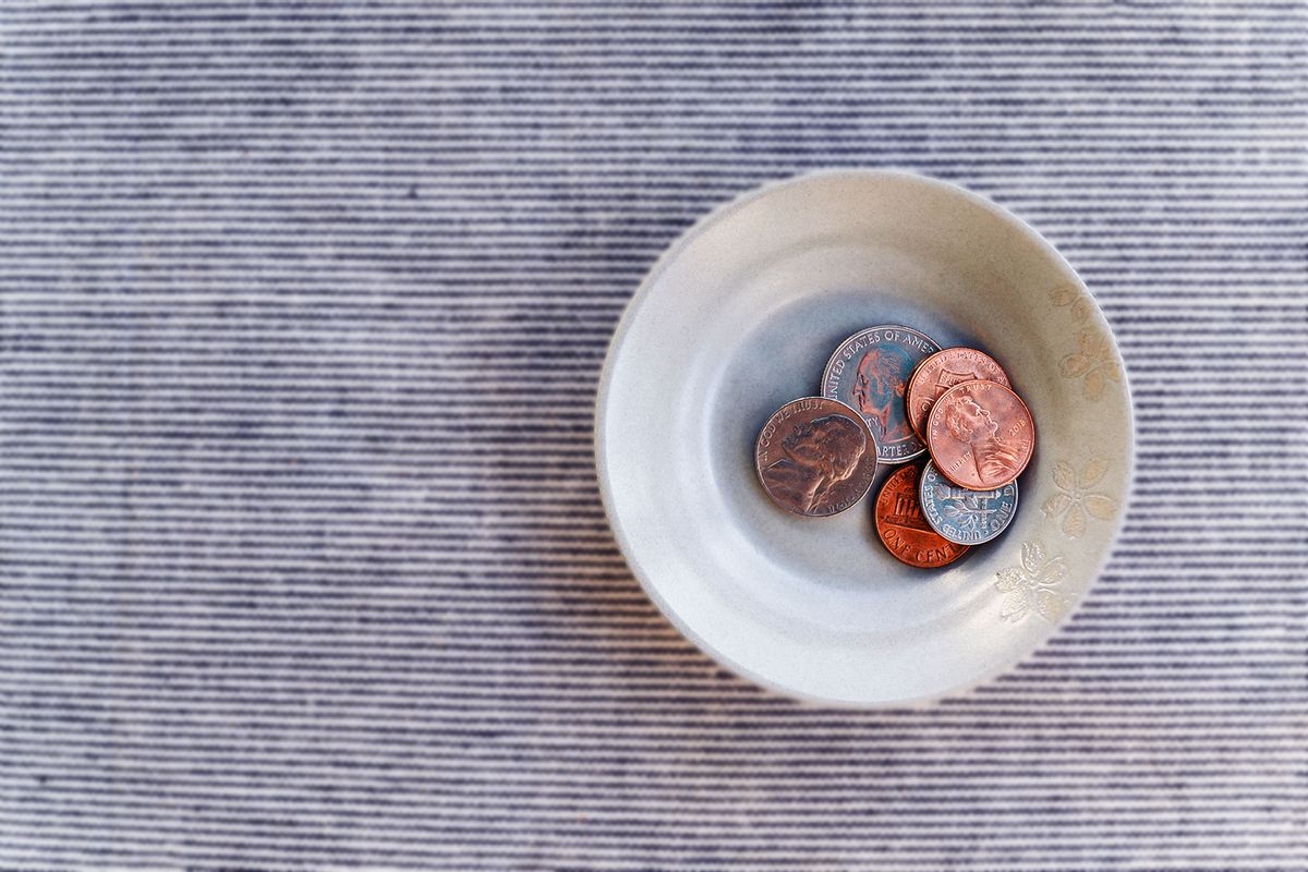 Bowl with small pile of coins (Getty Images/Jamie Grill)